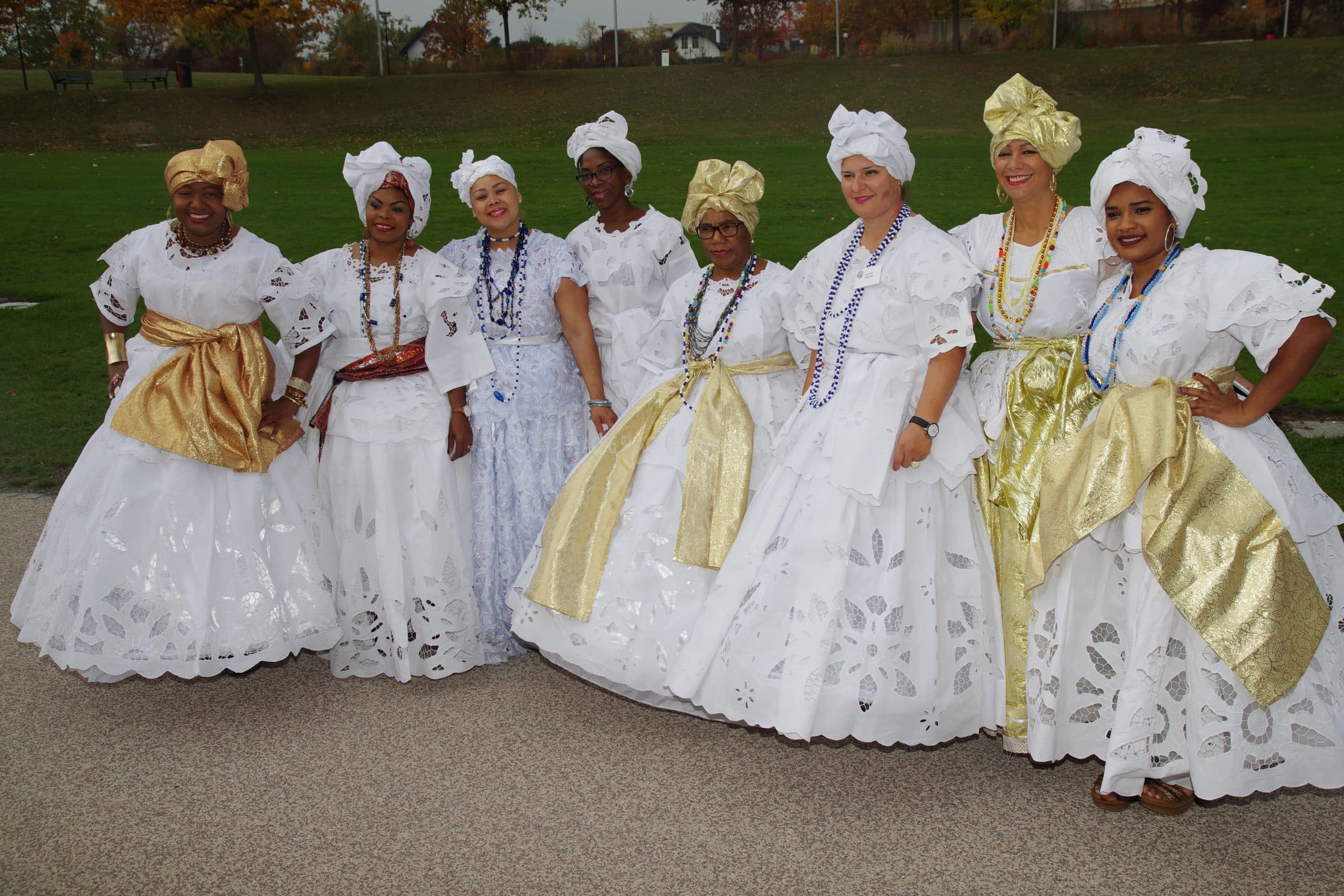 A group of women wearing white dresses