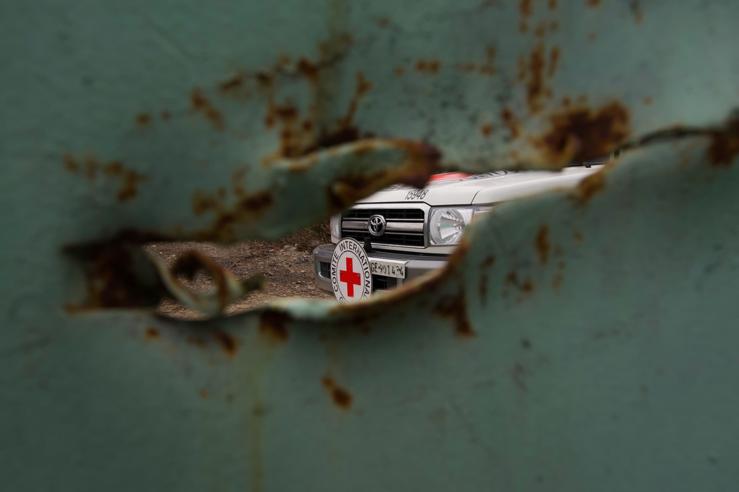 View of an ICRC vehicle through a shrapnel hole